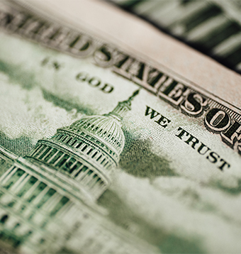 A close up of the back of a bill highlighting "In God We Trust"